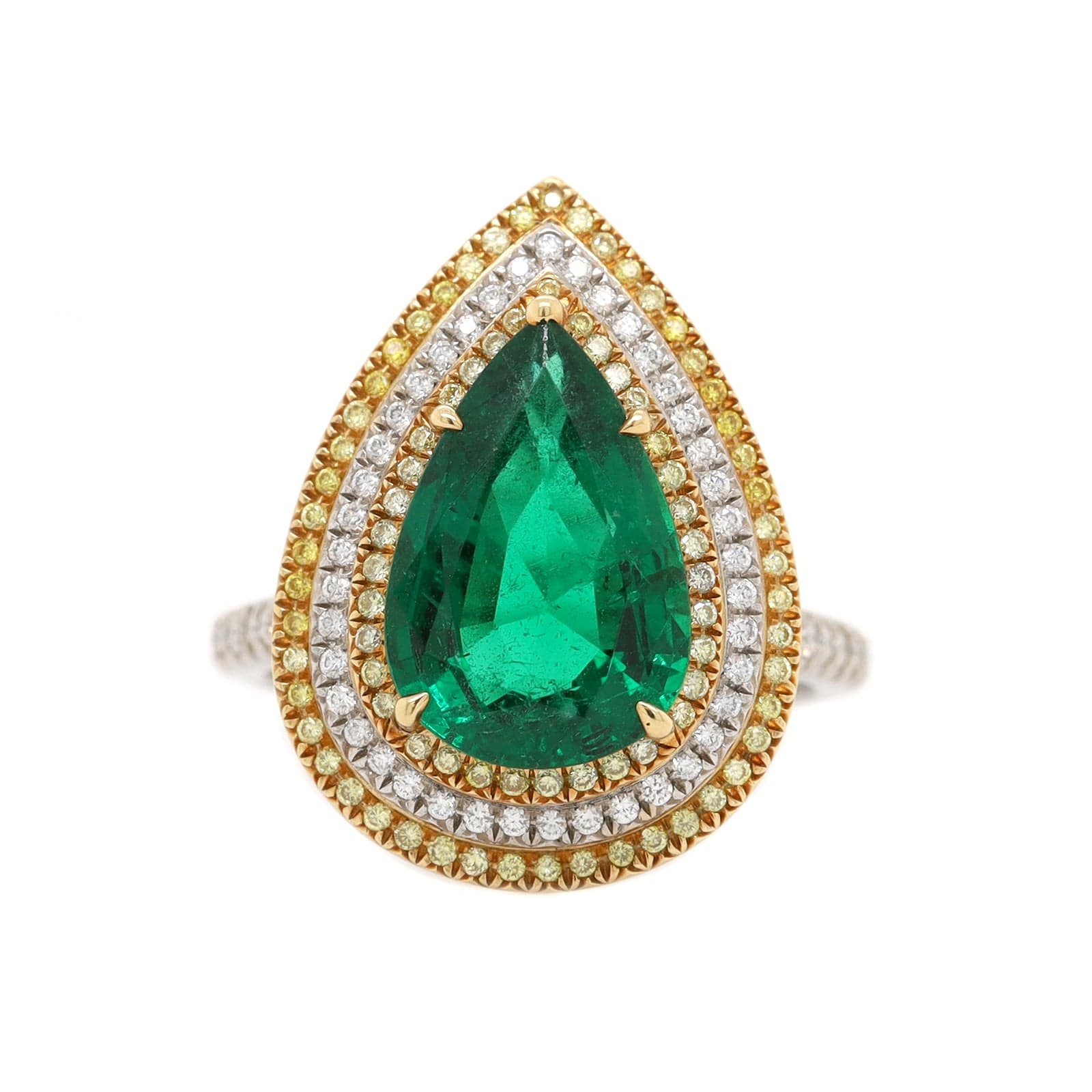 Platinum and 18K Yellow Gold Pear Shaped Emerald and Diamond Halo Ring