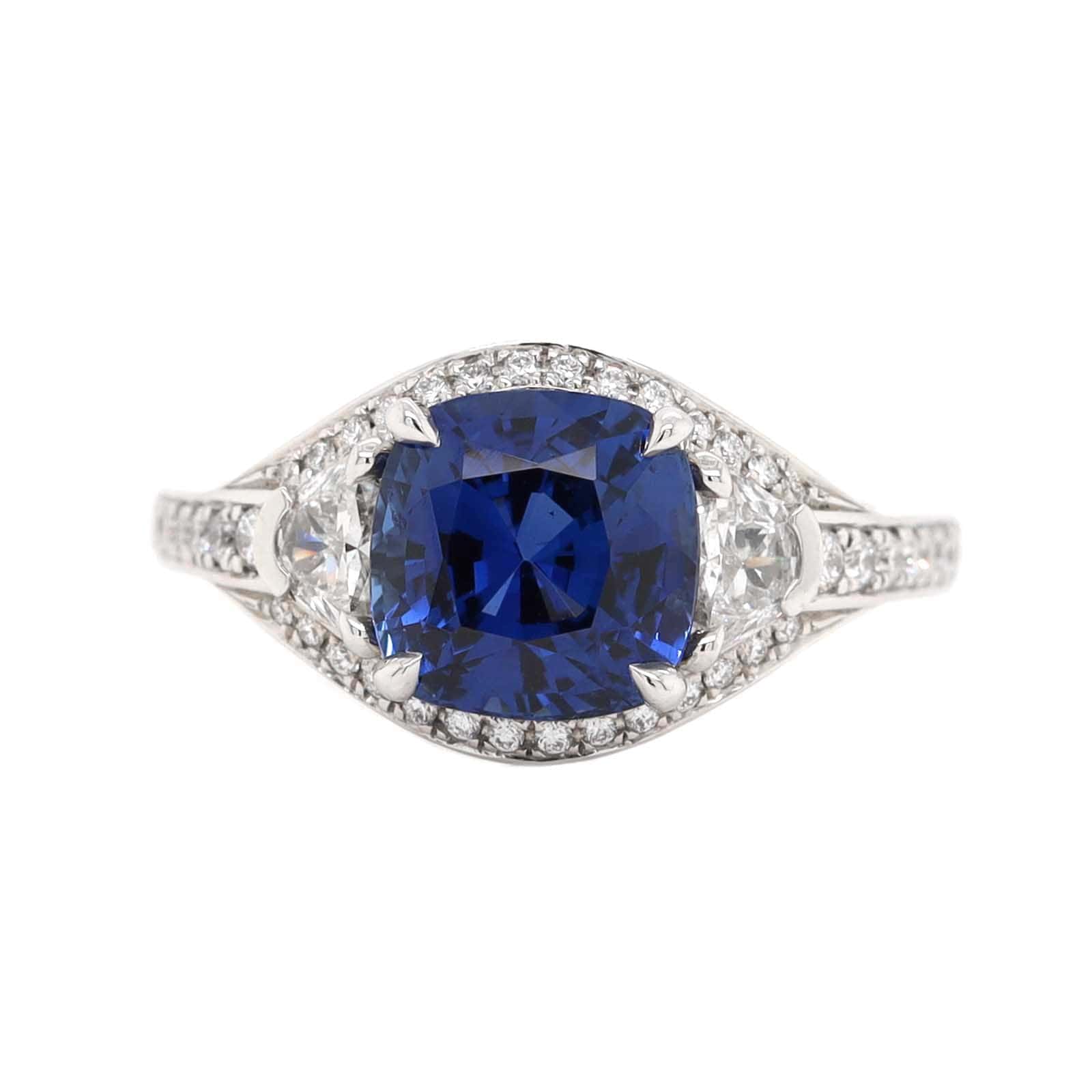 Platinum Three Stone Cushion Shaped Blue Sapphire and Diamond Halo Ring